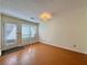 Cozy living room with wood floors, neutral paint, and ample natural light from sliding glass doors at 3533 Mulberry Way, Duluth, GA 30096