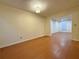 An empty living room featuring vinyl flooring, a light fixture, and a doorway into another room at 3533 Mulberry Way, Duluth, GA 30096