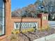 Attractive brick community sign for Woodhaven, showcasing manicured landscaping at 3533 Mulberry Way, Duluth, GA 30096