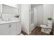 Well-lit bathroom featuring a shower-tub combo, wood-look flooring, and a white vanity with a modern sink and white trim at 4282 Worth Nw St, Acworth, GA 30101