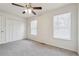 This bedroom features neutral carpet, a ceiling fan and two windows at 4282 Worth Nw St, Acworth, GA 30101