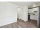 Open-concept kitchen area featuring stainless steel appliances, white cabinets, and hardwood-style flooring at 4282 Worth Nw St, Acworth, GA 30101