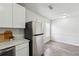 Bright eat-in kitchen featuring stainless steel refrigerator, white cabinets, and modern countertops at 4282 Worth Nw St, Acworth, GA 30101