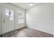 Mud room features wood-look vinyl flooring, white paint, natural lighting, and exterior door access at 4282 Worth Nw St, Acworth, GA 30101