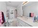 Bright bathroom featuring a shower-tub combo and a white single sink vanity at 1165 Saint Ives Ct, Suwanee, GA 30024