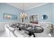Beautiful dining room with ample seating, stylish decor, and an open view into the living room at 1165 Saint Ives Ct, Suwanee, GA 30024