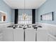 Elegant dining room with wainscoting, a chandelier, and seating for twelve, perfect for gatherings at 1165 Saint Ives Ct, Suwanee, GA 30024