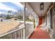 View from covered front porch showing stone accents, and a well-manicured lawn at 1165 Saint Ives Ct, Suwanee, GA 30024