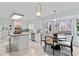 Bright kitchen with white cabinets, a breakfast nook, and large windows offering serene outdoor views at 1165 Saint Ives Ct, Suwanee, GA 30024