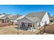 Aerial view of a backyard featuring a covered patio with outdoor seating, a fenced yard, and manicured lawn at 2764 Bateman Sw St, Powder Springs, GA 30127