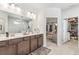 Elegant bathroom featuring dual sinks, dark wood cabinets, and a walk-in shower at 2764 Bateman Sw St, Powder Springs, GA 30127