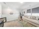 Upstairs bonus room with plush couch, mini-fridge, ship model, and plenty of light at 2764 Bateman Sw St, Powder Springs, GA 30127
