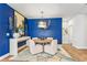 Elegant dining room with designer blue walls, round table, and stylish decor, creating an inviting atmosphere at 2764 Bateman Sw St, Powder Springs, GA 30127