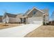 Charming single-Gathering home featuring a stone facade, two-car garage, and a cozy front porch at 2764 Bateman Sw St, Powder Springs, GA 30127