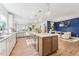 Bright, open kitchen features a large island, modern lighting, and hardwood floors at 2764 Bateman Sw St, Powder Springs, GA 30127