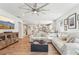Open-concept living room with wood floors, a large sectional, and seamless flow to the kitchen at 2764 Bateman Sw St, Powder Springs, GA 30127