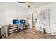 Bright home office space with modern desk, ample lighting, and hardwood floors at 2764 Bateman Sw St, Powder Springs, GA 30127