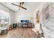 Well-lit home office with two monitors, ceiling fan, and hardwood floors at 2764 Bateman Sw St, Powder Springs, GA 30127