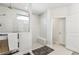 Modern walk-in shower featuring white tile, a glass enclosure, and a convenient bench at 2764 Bateman Sw St, Powder Springs, GA 30127