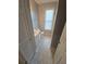 Neutral-toned bathroom with window and white fixtures at 3121 Baywood Ct, Conyers, GA 30013