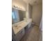 Bathroom featuring double sinks, large mirror with Hollywood lighting and separate tub and shower at 3121 Baywood Ct, Conyers, GA 30013