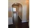 Inviting hallway features dark hardwood floors and elegant archway leading into the home at 3121 Baywood Ct, Conyers, GA 30013