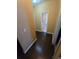 Hallway with dark hardwood floors leading to the bathroom at 3121 Baywood Ct, Conyers, GA 30013
