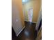 Hallway with dark hardwood floors leading to a bright, clean bathroom at 3121 Baywood Ct, Conyers, GA 30013