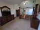 A spacious main bedroom featuring a vaulted ceiling and dark wood furniture, including a four-poster bed at 3121 Baywood Ct, Conyers, GA 30013