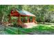 Lovely wooden gazebo with a metal roof nestled among the trees at 420 Hawkstone Way, Alpharetta, GA 30022