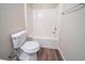 White bathroom features white tub, toilet, and neutral paint at 433 Kara Ln, Mcdonough, GA 30253