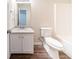 Bathroom featuring white cabinets, granite countertop, wood-look floors and a toilet at 433 Kara Ln, Mcdonough, GA 30253