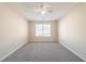 Inviting bedroom with plush carpeting, a ceiling fan, and ample natural light at 433 Kara Ln, Mcdonough, GA 30253