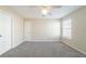 Spacious bedroom features soft carpet, a ceiling fan, and a large window for plenty of natural light at 433 Kara Ln, Mcdonough, GA 30253