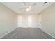 Large bedroom with plush carpeting, ceiling fan, neutral paint, and multiple closets for maximum storage space at 433 Kara Ln, Mcdonough, GA 30253