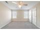 Bright bedroom with neutral paint, plush carpet, ceiling fan, and closet space for maximum storage at 433 Kara Ln, Mcdonough, GA 30253