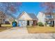 Charming single Gathering home with a manicured lawn, driveway, and blossoming trees in a suburban neighborhood at 433 Kara Ln, Mcdonough, GA 30253