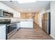 Modern kitchen features stainless steel appliances, granite countertops, white cabinets, and hardwood flooring at 433 Kara Ln, Mcdonough, GA 30253