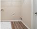 Neutral laundry room features wood-look floor at 433 Kara Ln, Mcdonough, GA 30253