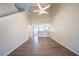 Open concept living room with soaring ceilings, modern ceiling fan, hardwood floors, and bright kitchen access at 433 Kara Ln, Mcdonough, GA 30253
