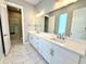 Modern bathroom with double sink vanity, quartz countertop, and tiled floor at 827 Winslow Nw Way, Atlanta, GA 30318
