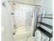 Well-lit bathroom with tub-shower, stylish tile, and modern fixtures at 827 Winslow Nw Way, Atlanta, GA 30318