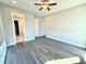 Spacious bedroom featuring hardwood floors, ceiling fan, and ensuite bathroom at 827 Winslow Nw Way, Atlanta, GA 30318