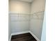 Walk-in closet with sleek gray walls, wire shelving, and dark wood floors at 827 Winslow Nw Way, Atlanta, GA 30318