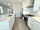 Kitchen area featuring an island with marble countertop, stainless steel appliances and white cabinets at 827 Winslow Nw Way, Atlanta, GA 30318