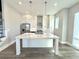 Kitchen area featuring an island, stainless steel appliances, pendant lights and white cabinets at 827 Winslow Nw Way, Atlanta, GA 30318