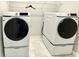 Laundry room featuring white front load Samsung washer and dryer on pedestals at 827 Winslow Nw Way, Atlanta, GA 30318