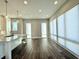 Open living room and kitchen featuring hardwood floors, pendant lights and windows with shades at 827 Winslow Nw Way, Atlanta, GA 30318