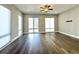 Open living room with hardwood floors, recessed lights and three windows with shades at 827 Winslow Nw Way, Atlanta, GA 30318