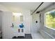 Bathroom featuring glass bowl sink, shower with bench, and window for plenty of natural light at 2133 Creekview Trl, Decatur, GA 30035